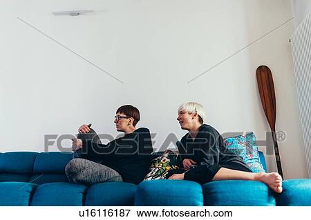 Women sitting on sofa View Large Photo Image Stock Photo - Women sitting on sofa. Fotosearch