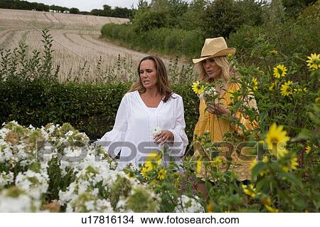 Picture - Women working on garden in countryside. Fotosearch