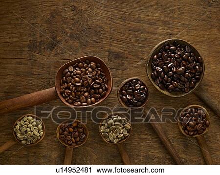 Stock Image - Wooden spoons with coffee beans.. Fotosearch