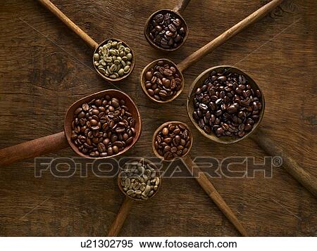 Stock Photography - Wooden spoons with coffee beans.. Fotosearch