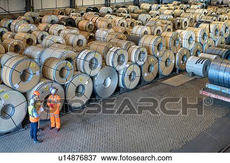 Stock Photo - Workers with rows of sheet steel in storage at port. Fotosearch