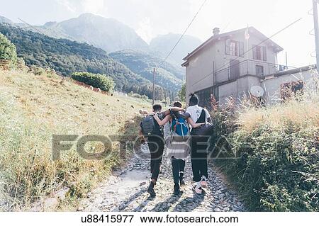 Young adult hiker friends with arms around each other on rural road, Primaluna, Trentino-Alto Adige, Italy View Large Photo Image Stock Photo - Young adult hiker friends with arms around each other on rural road, Primaluna, Trentino-Alto Adige, Italy. Fotosearch