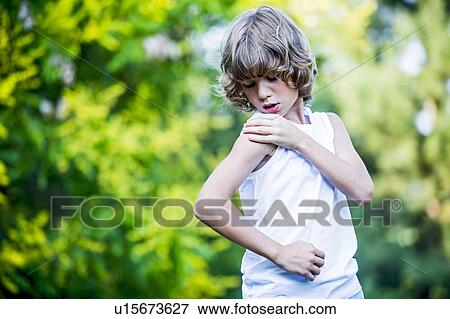 Young boy scratching arm. View Large Photo Image Stock Photo - Young boy scratching arm.. Fotosearch