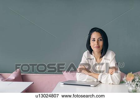 Young businesswoman at hotel table, portrait View Large Photo Image Stock Photo - Young businesswoman at hotel table, portrait. Fotosearch