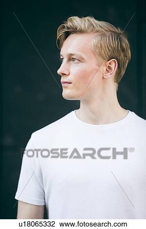 Young man, black background View Large Photo Image Stock Image - Young man, black background. Fotosearch