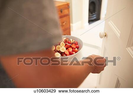 Young man carrying breakfast tray into bedroom, close up View Large Photo Image Stock Photo - Young man carrying breakfast tray into bedroom, close up. Fotosearch