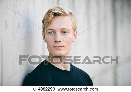 Stock Image - Young man daydreaming. Fotosearch