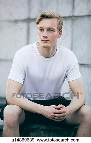 Stock Photo - Young man daydreaming. Fotosearch