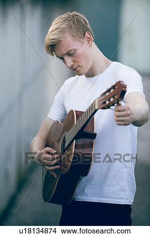 Picture - Young musician playing guitar. Fotosearch