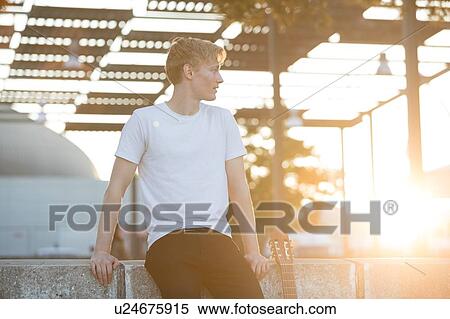 Stock Photography - Young musician with guitar in park. Fotosearch