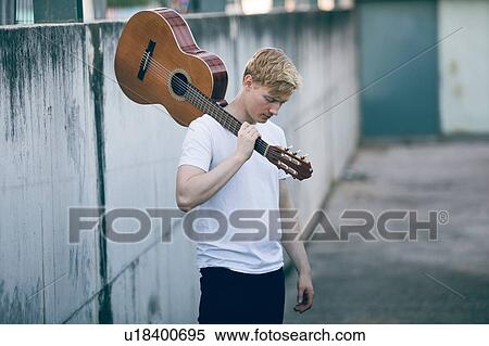 Stock Photography - Young musician with guitar. Fotosearch