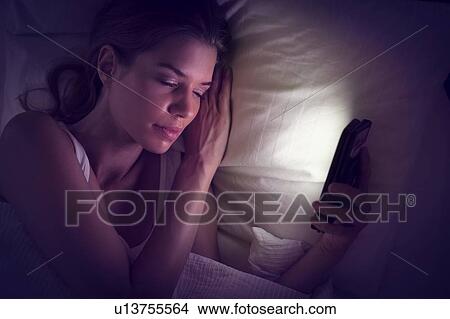 Young woman falling asleep with smartphone View Large Photo Image Picture - Young woman falling asleep with smartphone. Fotosearch