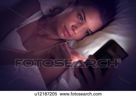 Young woman using digital tablet in bed View Large Photo Image Stock Photography - Young woman using digital tablet in bed. Fotosearch