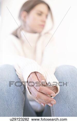 Young woman with hands clasped View Large Photo Image Stock Image - Young woman with hands clasped. Fotosearch