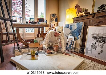 Artist working on canvas in studio View Large Photo Image Stock Image - Artist working on canvas in studio. Fotosearch