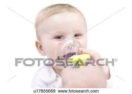 Stock Photo - Baby boy using nebuliser.. Fotosearch
