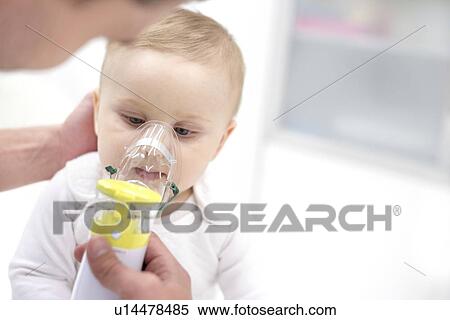Stock Photography - Baby boy using nebuliser.. Fotosearch