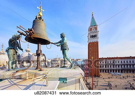 Stock Image - Bell on St Marks clock tower with view of St marks Square, Venice, Veneto, Italy. Fotosearch