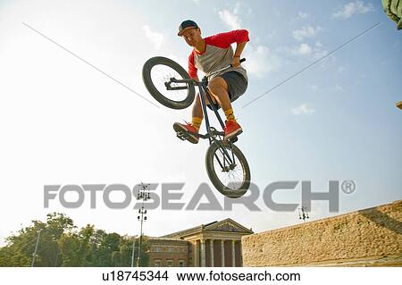 Picture - BMX cyclist doing stunt, Heroes Square (Hosk Tere), Budapest, Hungary. Fotosearch