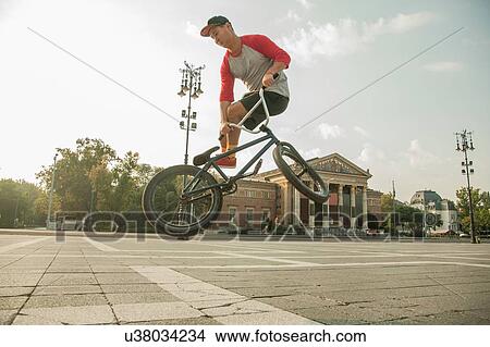Picture - BMX cyclist doing stunt, Heroes Square (Hosk Tere), Budapest, Hungary. Fotosearch