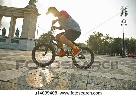 Stock Photo - BMX cyclist doing stunt, Heroes Square (Hosk Tere), Budapest, Hungary. Fotosearch