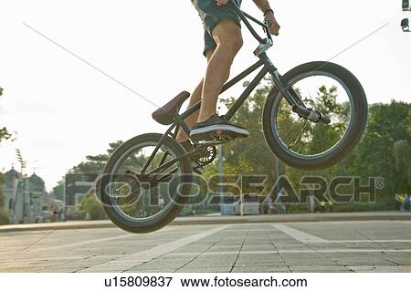 Stock Photo - BMX cyclist doing stunt, Heroes Square (Hosk Tere), Budapest, Hungary. Fotosearch