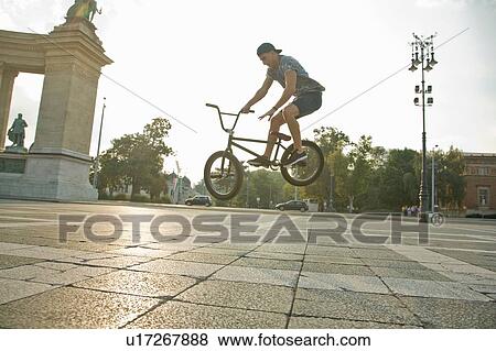 BMX cyclist doing stunt, Heroes Square (Hosk Tere), Budapest, Hungary View Large Photo Image Stock Photo - BMX cyclist doing stunt, Heroes Square (Hosk Tere), Budapest, Hungary. Fotosearch