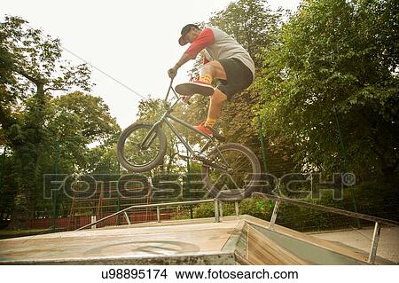 Picture - BMX cyclist doing stunt on ramp. Fotosearch