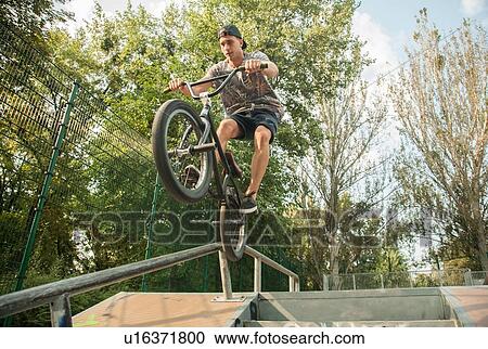 Stock Image - BMX cyclist doing stunt on ramp. Fotosearch