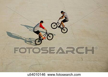 Stock Photograph - BMX cyclist doing stunts. Fotosearch