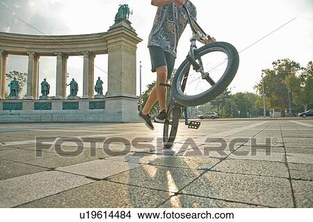 BMX cyclist doing wheelie, Heroes Square (Hosk Tere), Budapest, Hungary View Large Photo Image Picture - BMX cyclist doing wheelie, Heroes Square (Hosk Tere), Budapest, Hungary. Fotosearch
