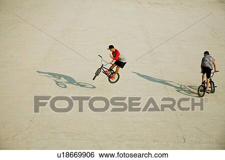 BMX cyclists doing stunts View Large Photo Image Stock Photograph - BMX cyclists doing stunts. Fotosearch