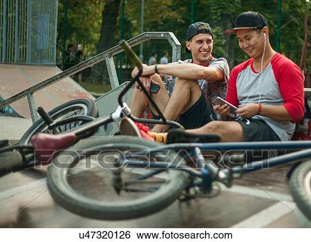 BMX cyclists resting beside ramp View Large Photo Image Stock Photograph - BMX cyclists resting beside ramp. Fotosearch