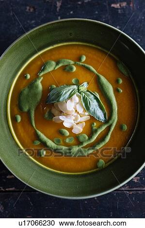Stock Image - Bowl of fresh garnished soup, overhead view. Fotosearch