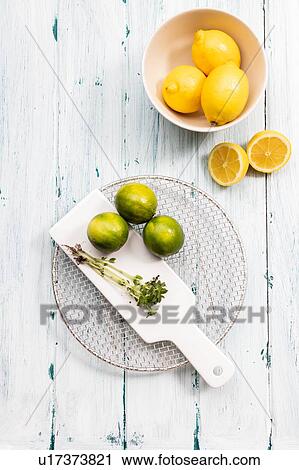 Bowl of lemons with limes on chopping board, still life, overhead view View Large Photo Image Stock Image - Bowl of lemons with limes on chopping board, still life, overhead view. Fotosearch