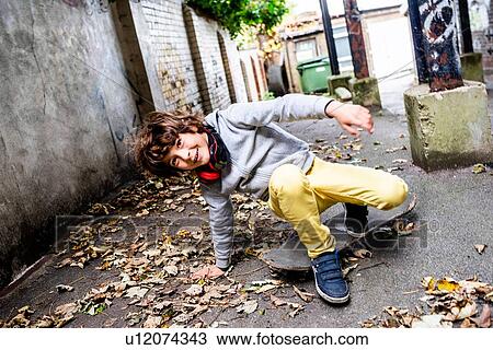 Boy falling off skateboard on street View Large Photo Image Stock Image - Boy falling off skateboard on street. Fotosearch