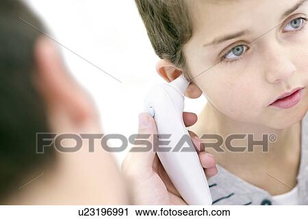 Boy having his temperature taken with a digital thermometer. View Large Photo Image Stock Image - Boy having his temperature taken with a digital thermometer.. Fotosearch