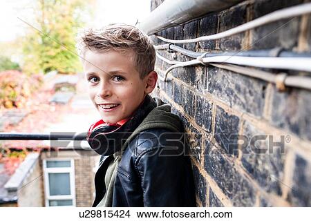 Boy leaning against brickwall View Large Photo Image Picture - Boy leaning against brickwall. Fotosearch