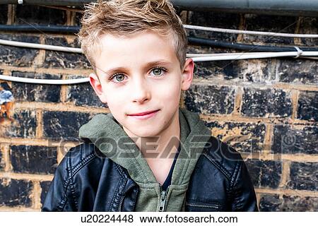 Boy leaning against brickwall View Large Photo Image Stock Photo - Boy leaning against brickwall. Fotosearch