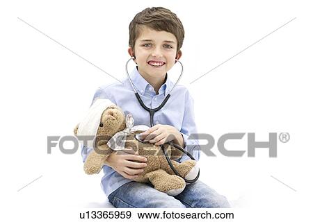 Boy playing with teddy bear and stethoscope. View Large Photo Image Stock Photo - Boy playing with teddy bear and stethoscope.. Fotosearch