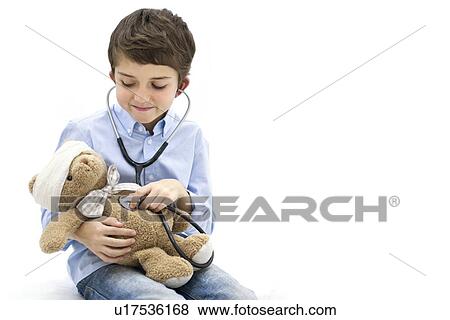 Boy role playing with teddy bear and stethoscope. View Large Photo Image Stock Photo - Boy role playing with teddy bear and stethoscope.. Fotosearch