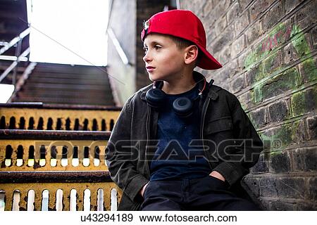 Boy sitting on metal staircase View Large Photo Image Stock Photo - Boy sitting on metal staircase. Fotosearch