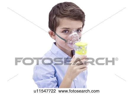 Stock Image - Boy using nebuliser. Fotosearch