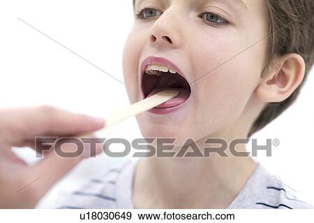Boy with mouth open and tongue depressor. View Large Photo Image Stock Photo - Boy with mouth open and tongue depressor.. Fotosearch