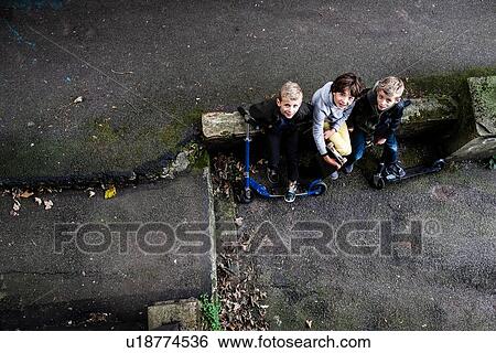 Boys looking up from ground level View Large Photo Image Stock Photograph - Boys looking up from ground level. Fotosearch