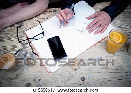 Stock Photo - Business people brainstorming ideas during coffee break. Fotosearch