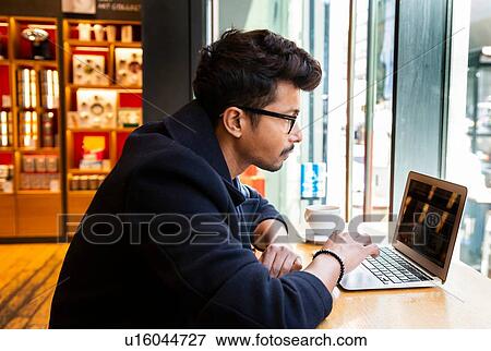 Businessman using laptop in cafe View Large Photo Image Stock Photo - Businessman using laptop in cafe. Fotosearch