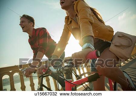 Couple crossing bridge on bicycles, Budapest, Hungary View Large Photo Image Stock Image - Couple crossing bridge on bicycles, Budapest, Hungary. Fotosearch