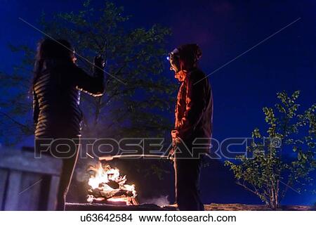 Couple having barbecue on Nexen Beach, Squamish, Canada View Large Photo Image Picture - Couple having barbecue on Nexen Beach, Squamish, Canada. Fotosearch