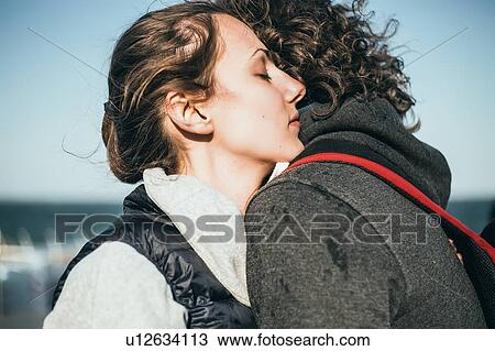 Couple hugging at coast, close up View Large Photo Image Stock Image - Couple hugging at coast, close up. Fotosearch